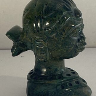 Green stone female bust with a carved hairstyle and pierced collar measuring 6 cm high
